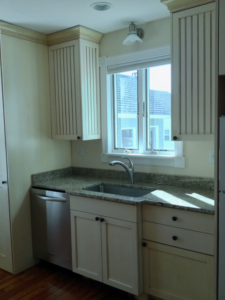 Custom beadboard kitchen cabinetry with granite counters and undermount sink, built and finished on site at a home renovation in Mystic, CT